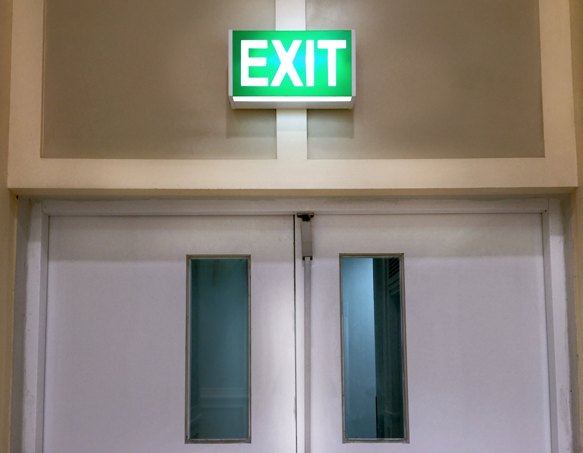 Closed Door with Glowing Emergency Exit Label