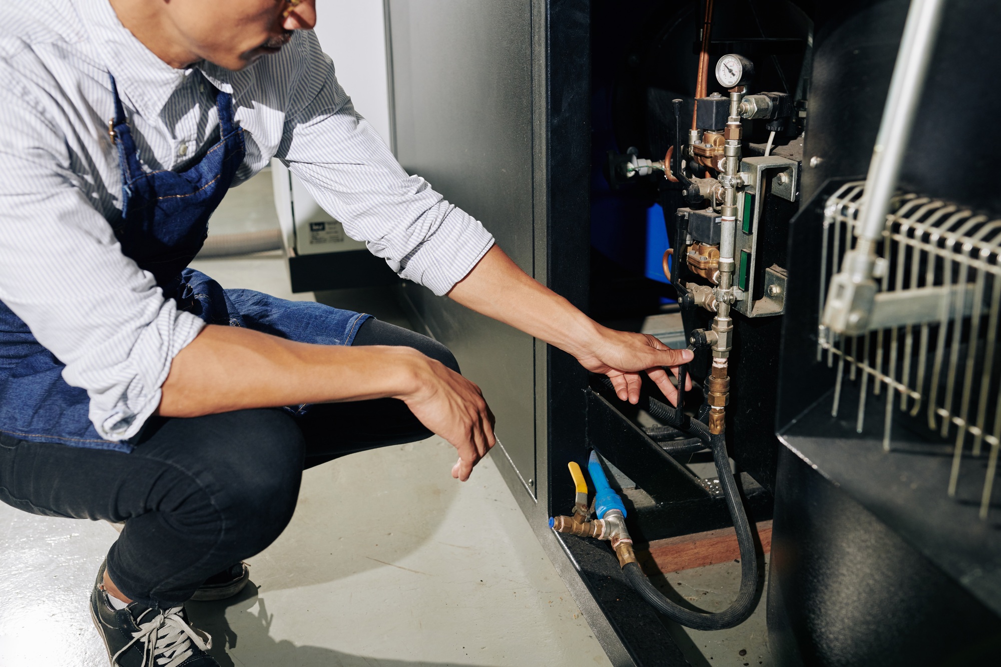 Man turning on gas supply